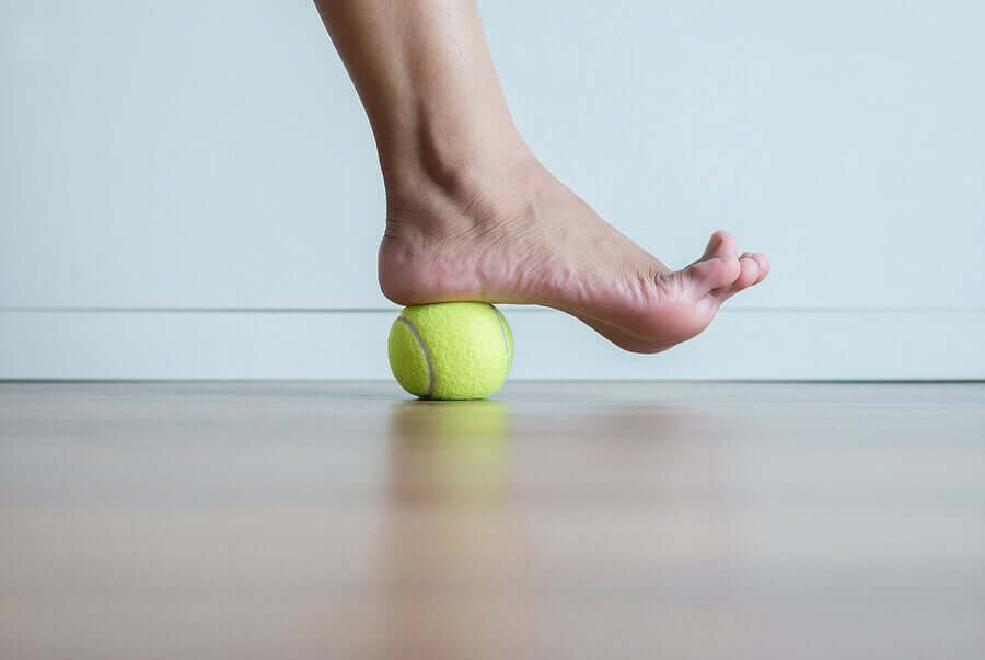 A man exercising with a tennis ball.