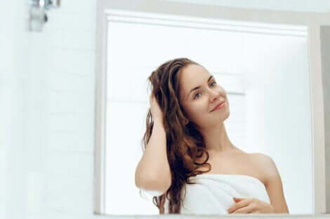 A woman looking at herself in a mirror.