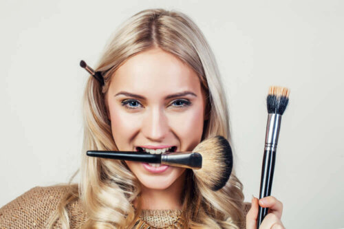 A woman with makeup brushes.
