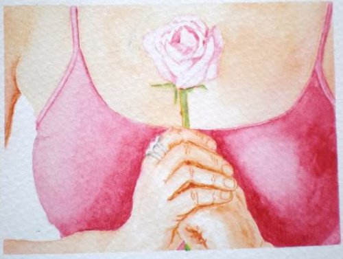 Woman holding a rose to her chest.