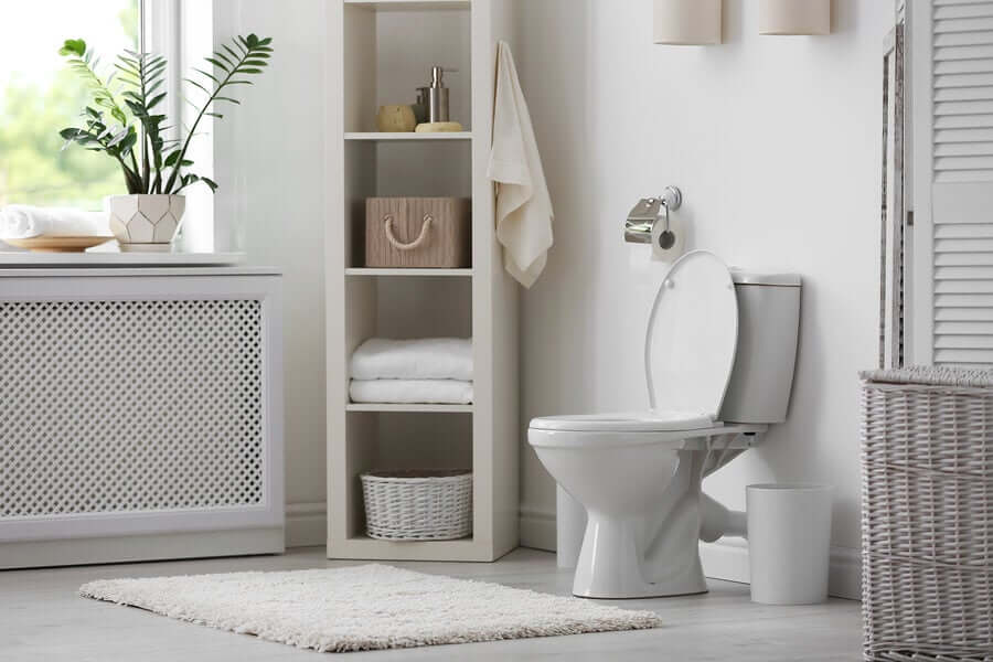 A bathroom with shelves and bastkets.