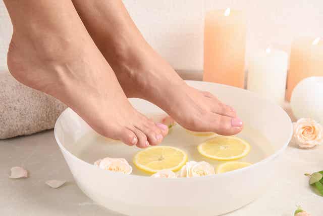 A woman preparing a foot soak.