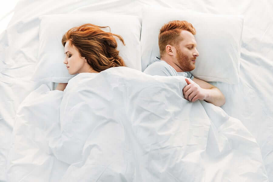 Partners sleeping side-by-side.