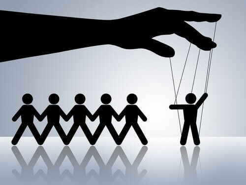 A manipulative person controlling puppets.