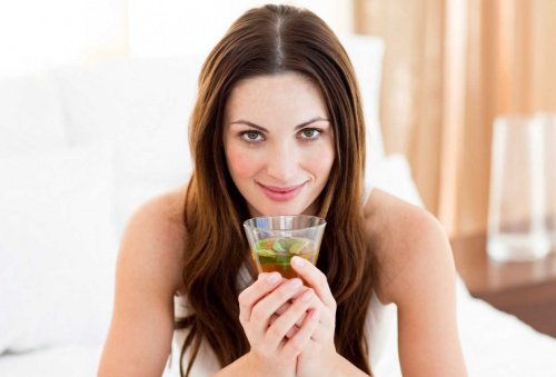 Woman drinking a glass of green tea lemonade