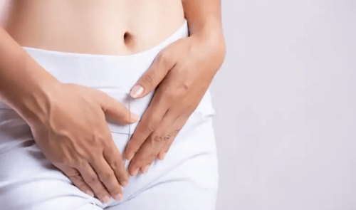 A person with pain in their low stomach.