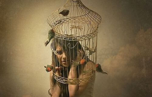 Abused women young woman inside a birdcage psychologically trapped from abuse and violence