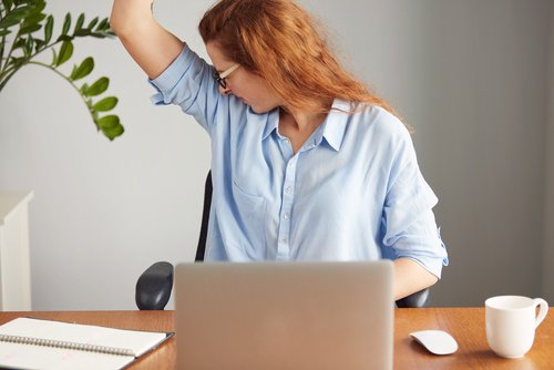 Woman smelling her armpits