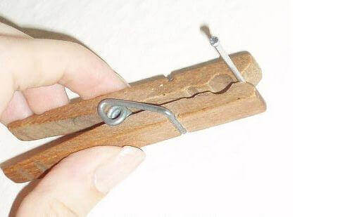 Holding a nail with a clothespin