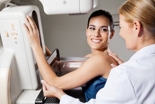 Doctor giving woman breast exam healthy breasts