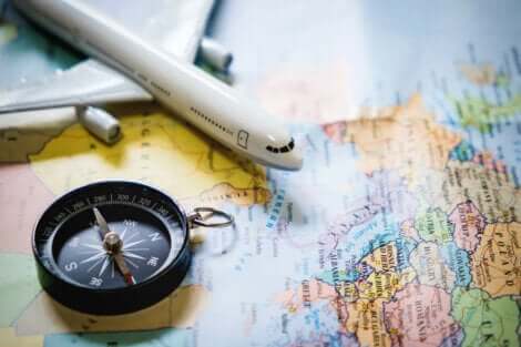 A map, toy airplane and compass.