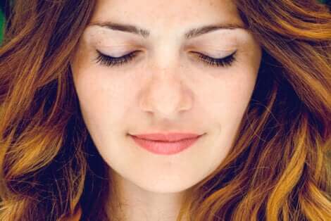 A woman with her eyes closed.