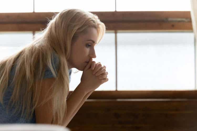 A woman looking thoughtful.