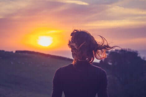 A woman watching a sunset.