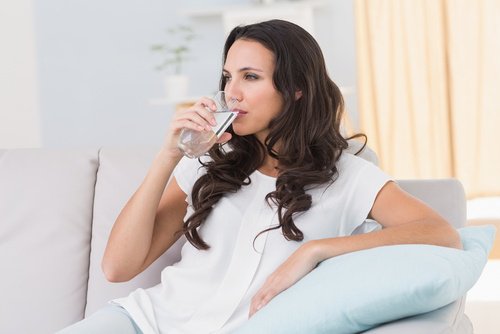 woman drinking a glass of water