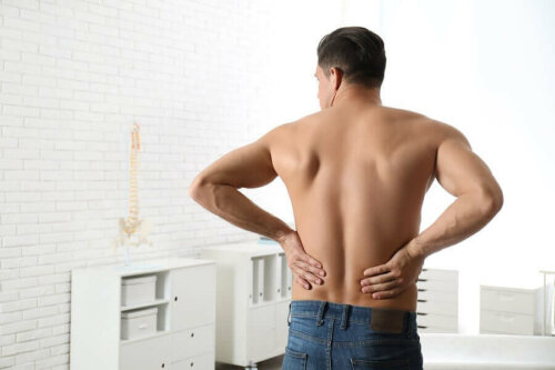 A man touching his low back.