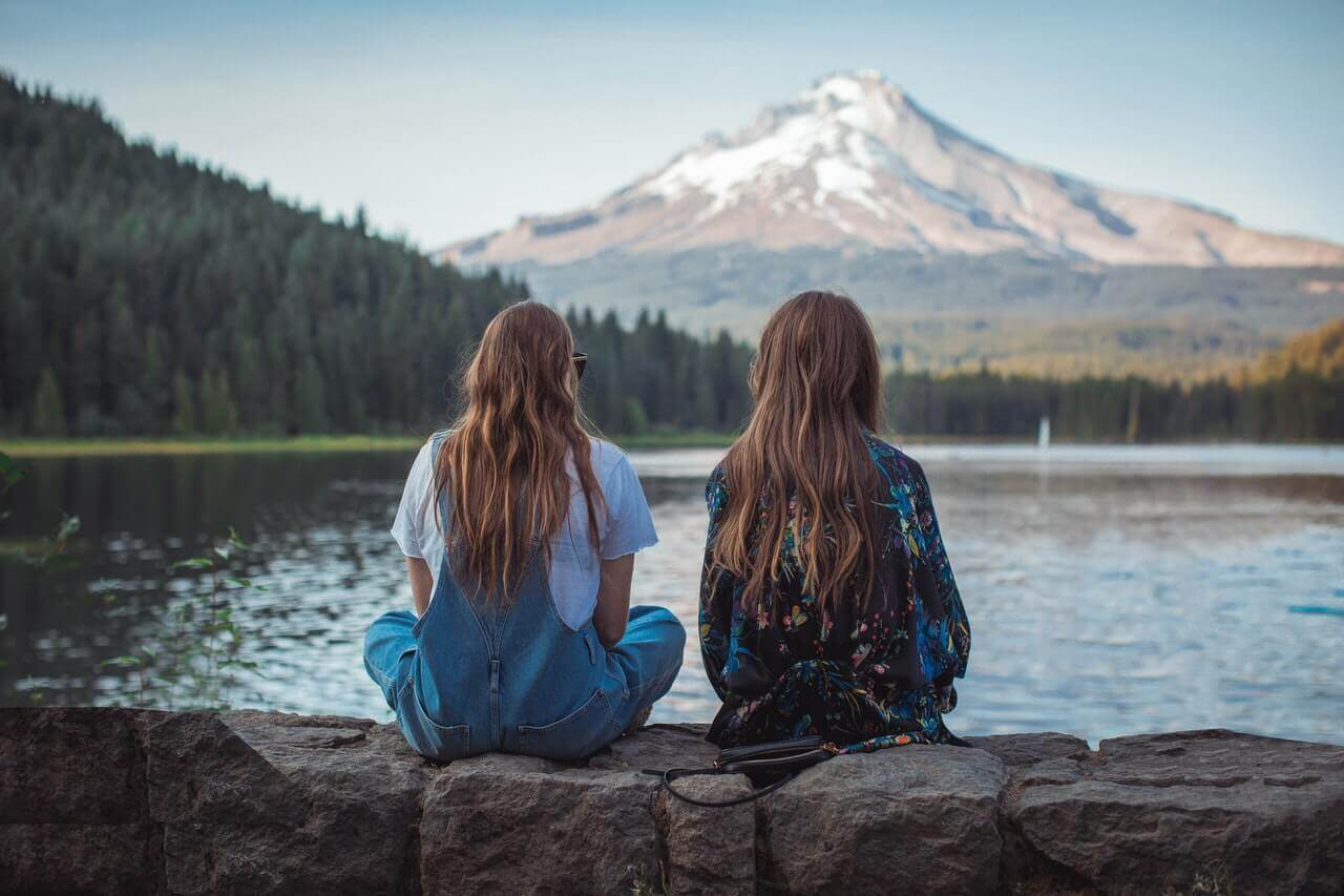 Two friends looking at mountains.