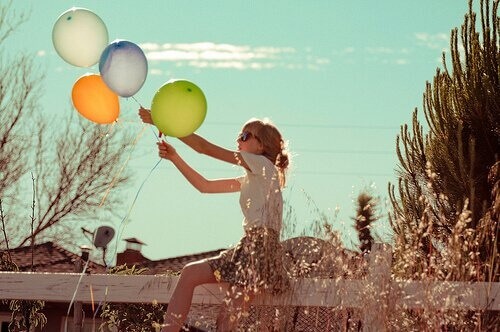 Woman holding balloons