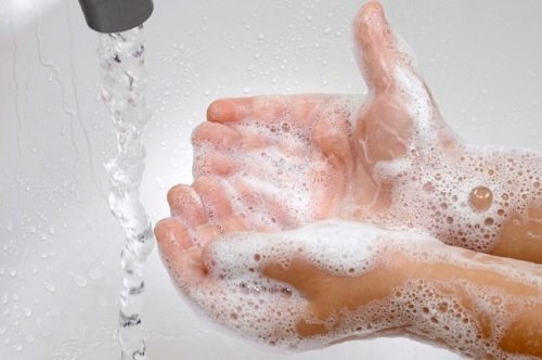 A person washing their hands.