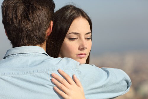 Sad woman hugging her partner