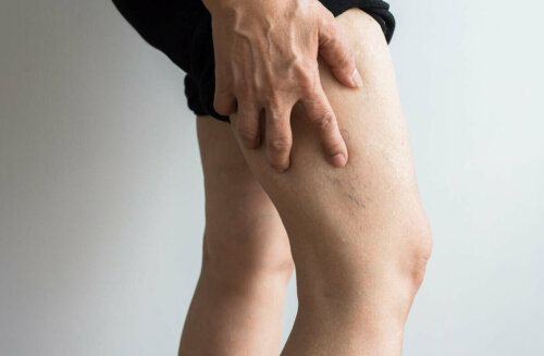 A person feeling their legs.