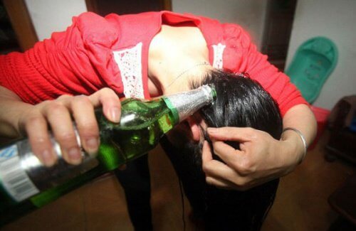 Woman applying beer on her hair.