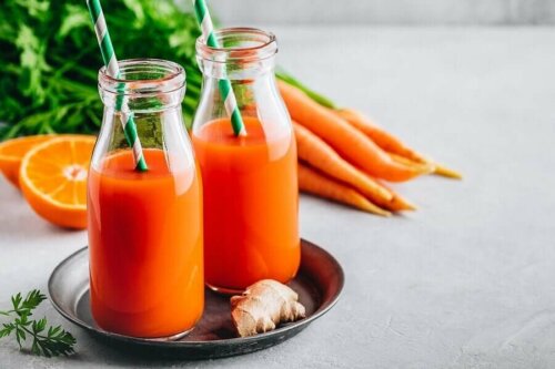 Two bottles of carrot and ginger juice.
