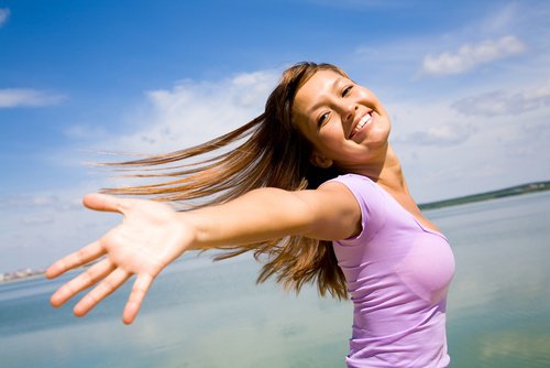 Girl smiling by the water with endorphin high