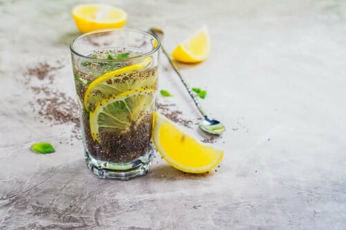 A glass of lemon, ginger, and chia seed drink.