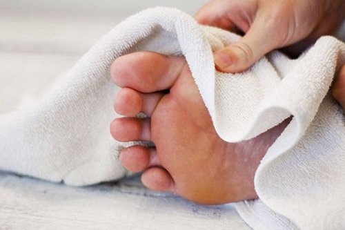 Drying your feet with a towel