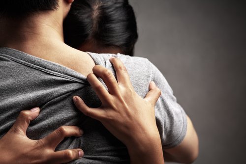 A couple embracing.