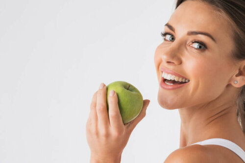 A woman holding an apple.