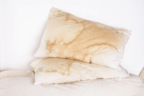 Some dirty pillows on a bed.