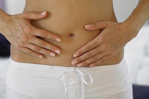 Woman touching bare stomach fight digestive problems