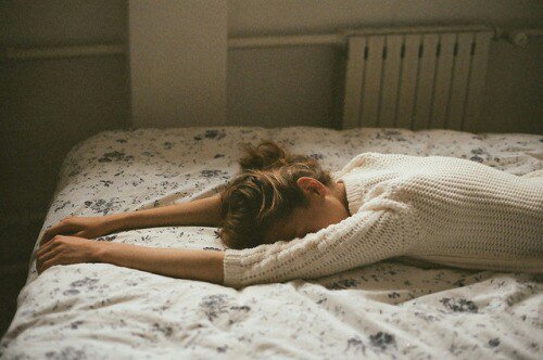 Woman crying on her bed
