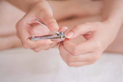 A woman cutting her fingernails.