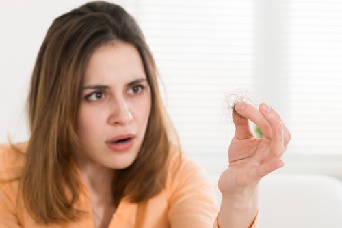 Woman gawking at hair loss