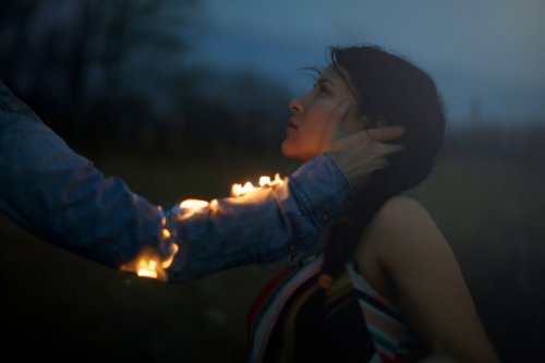 Woman around a bonfire.