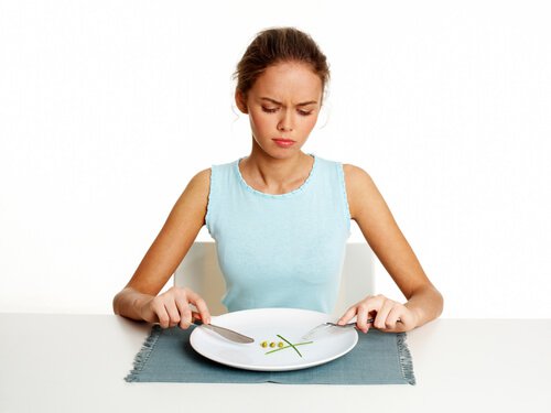 Woman with hardly any food on her plate