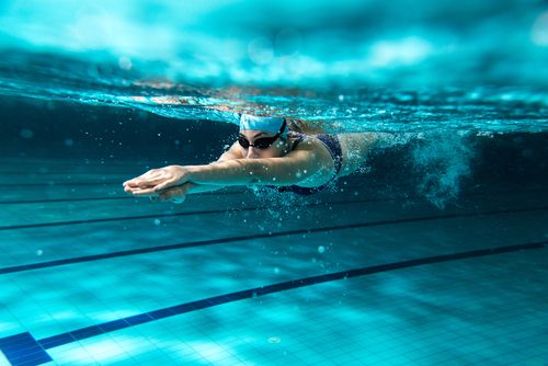 Woman swimming underwater.