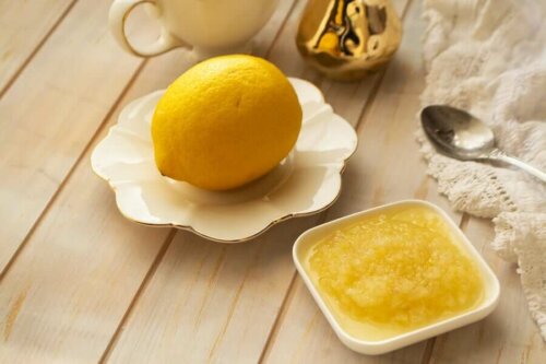 A lemon and lemon paste on a table.