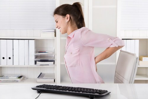 Woman back pain due to bad posture