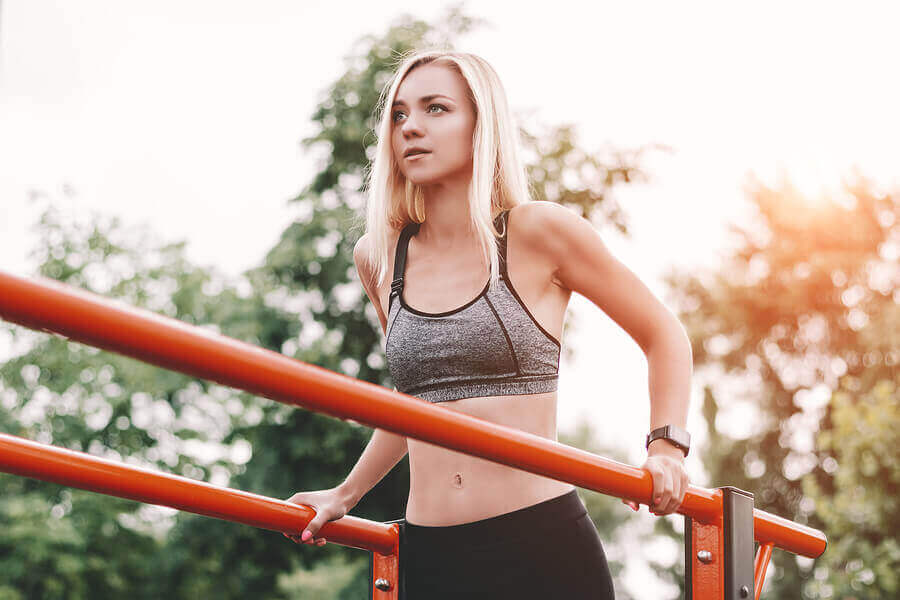 A woman doing tricep dips.