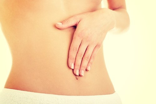 Flat belly woman touching stomach benefits of eating oats