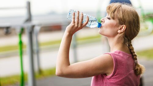 Woman drinking a bottle of water