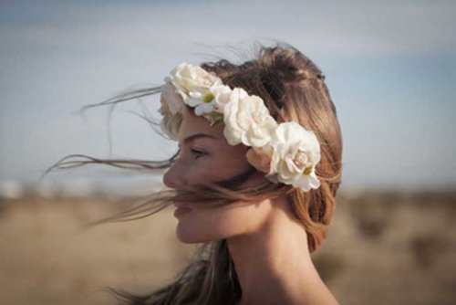 Woman with flower crown wind blowing accept your present situation