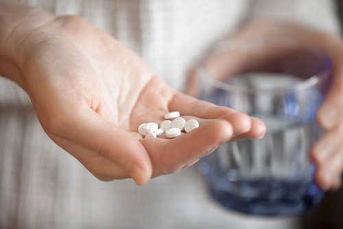A person holding pills.