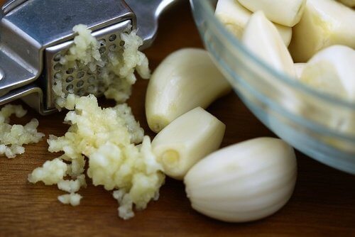 Garlic being cut and grated.