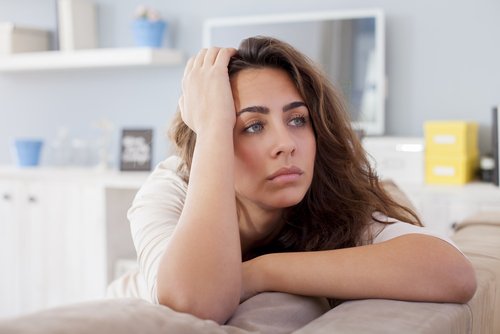 a sad woman thinking about if she is over her ex