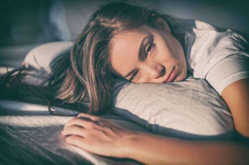 A tired woman in bed.
